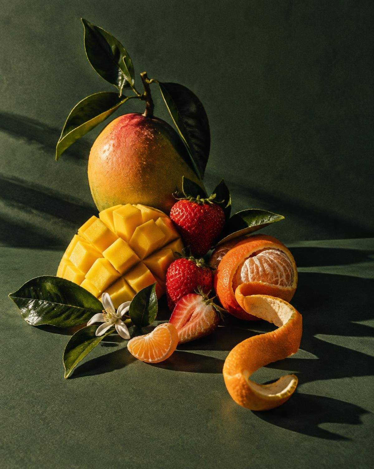 Mango, strawberries and citrus arranged as a Freuts still life